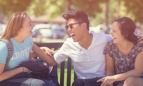 Three laughing students
